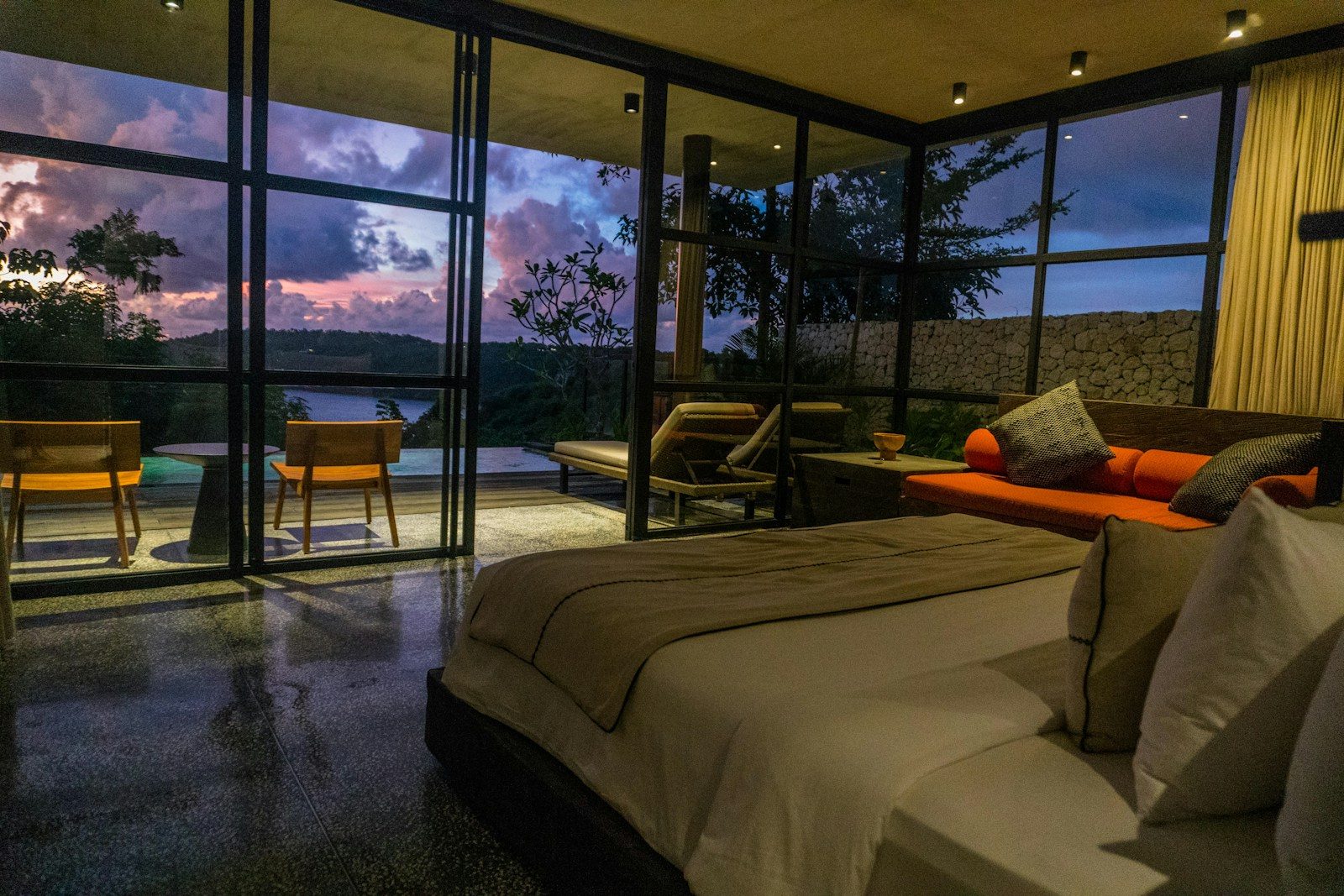 A bedroom with a large bed sitting next to a window